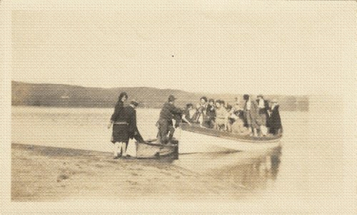 black and white photo of a large group of people in a small boat on the shore