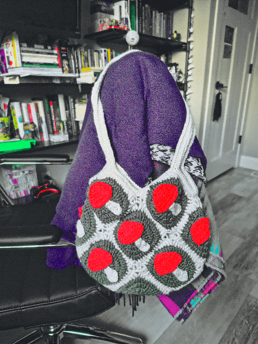 a crochet granny square bag with mushroom decorations