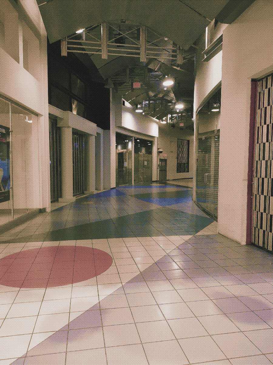 an abandoned corridor of a mall with late 80s/early 90s era design