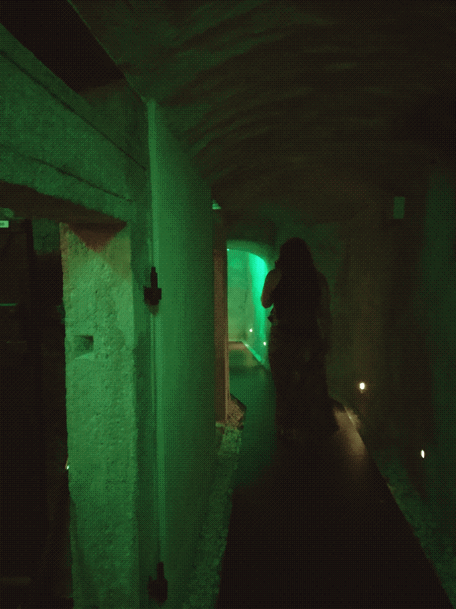 an underground hallway lit in neon green