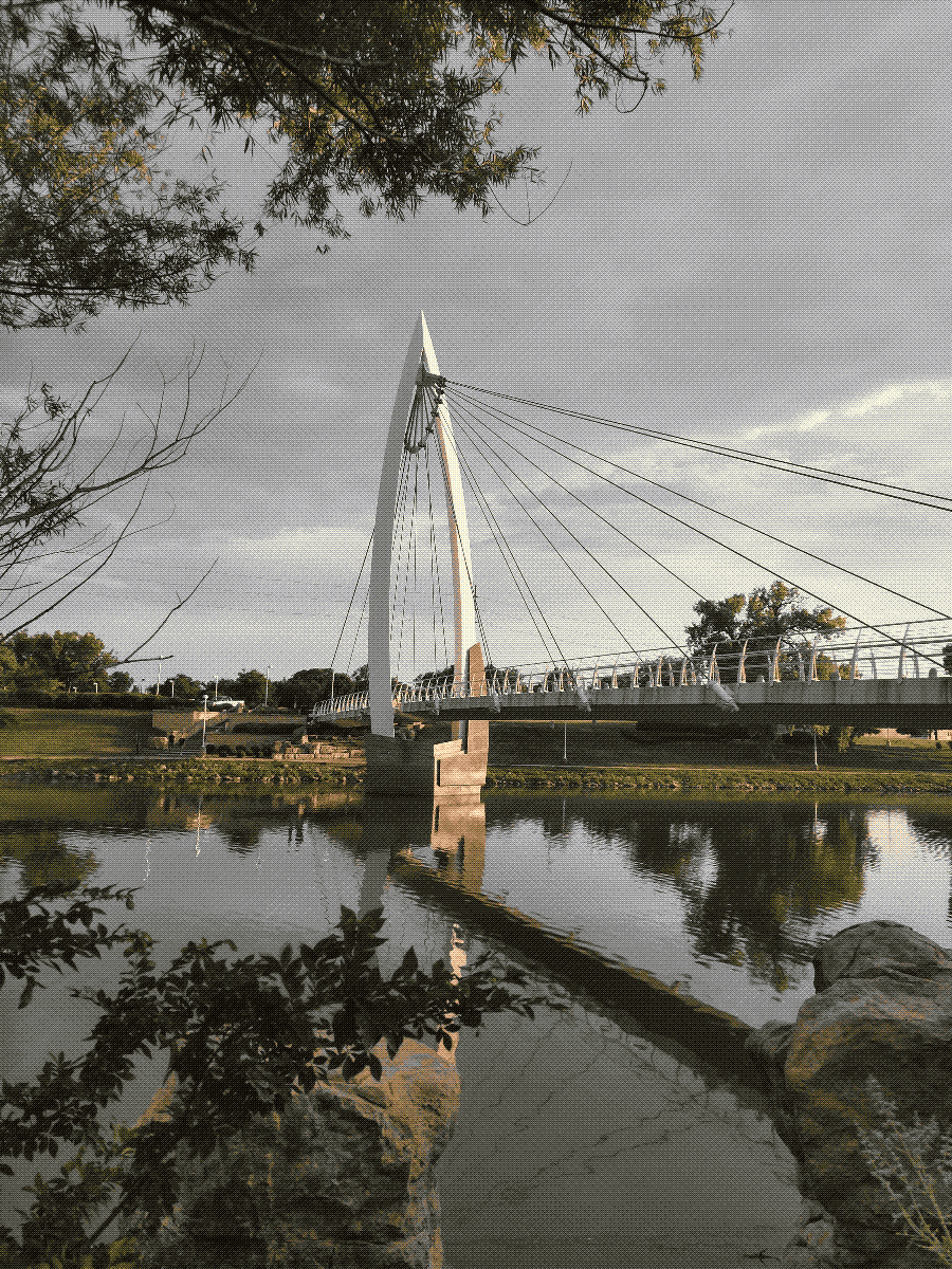 a tall, modern-looking bridge stretching across a wide river