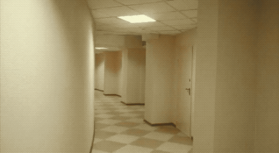 a curved hallway with many closed doors, checkered floors, and white, undecorated walls and ceilings