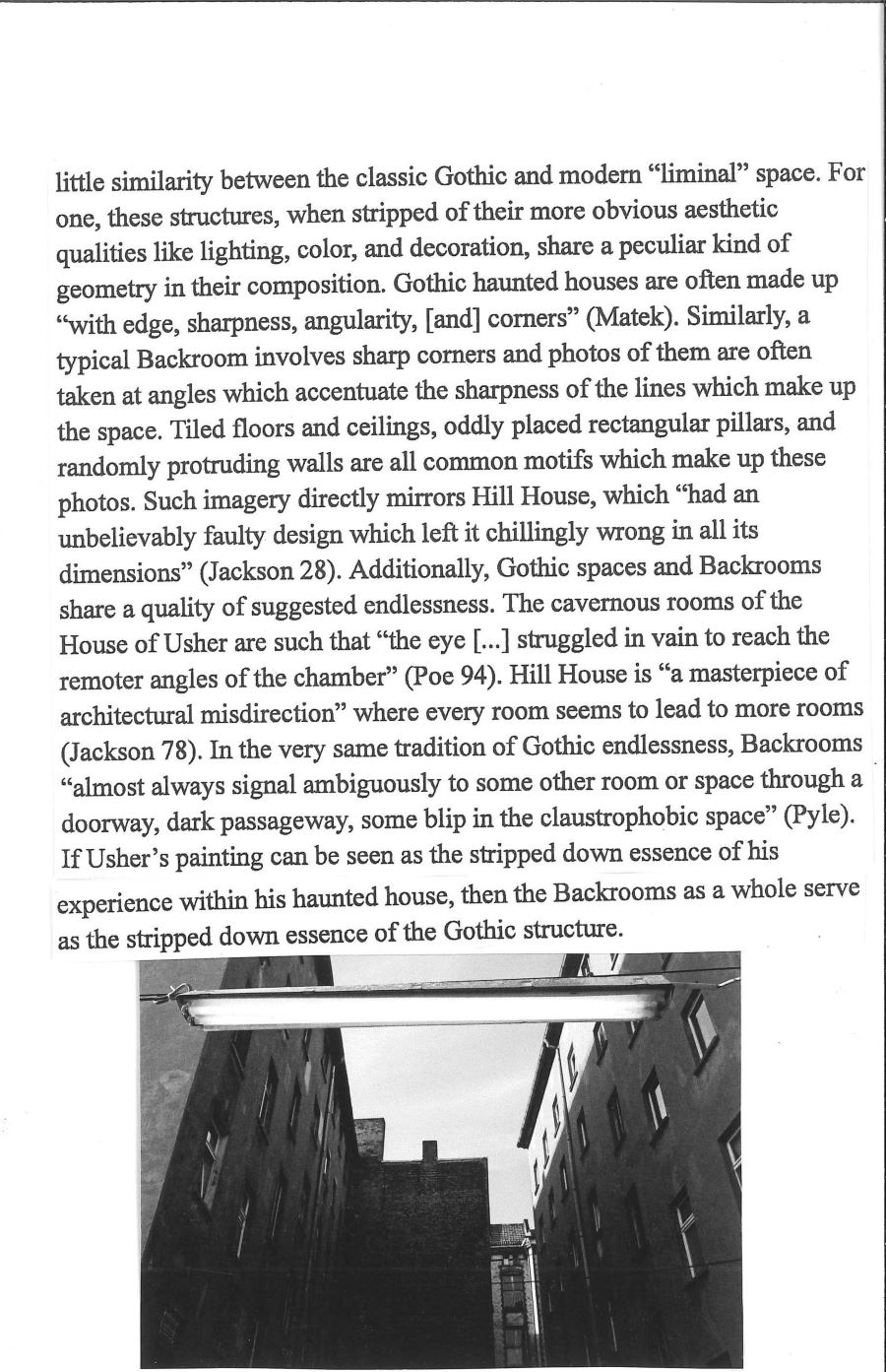 essay text and a photo of buildings