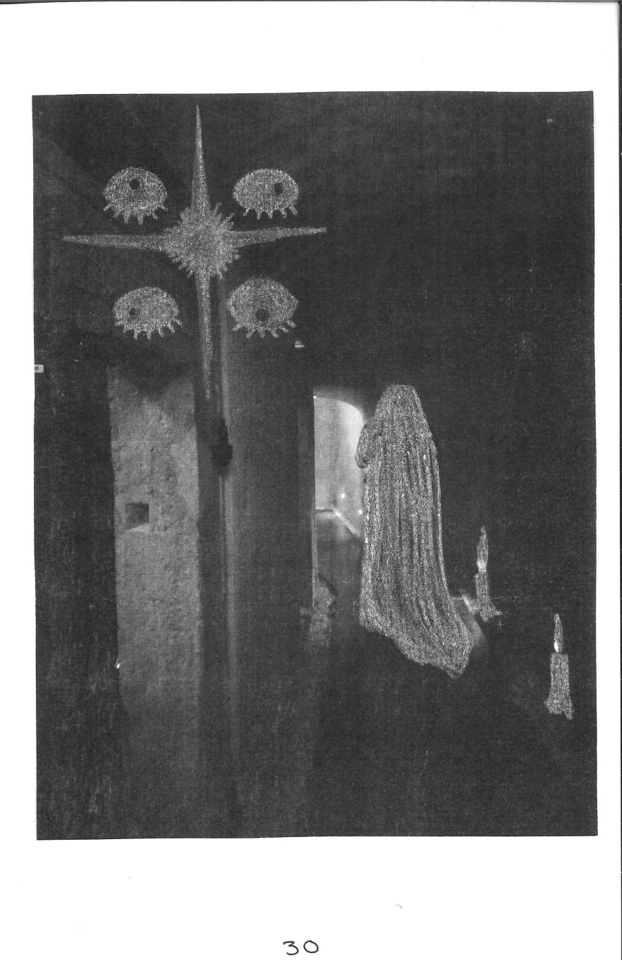 photo of a dark, shadowy hallway with a ghost, candles, and a star surrounded by eyes drawn onto it